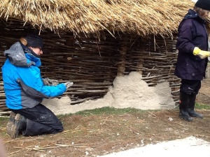 Suzanne applies the daub to the wall of building 851.